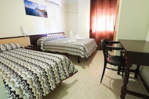 Postel nebo postele na pokoji v ubytování Hostal la Campana