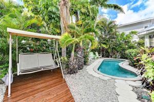 a backyard with a swimming pool and a house at Harmony House in Anna Maria