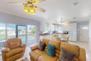 a living room with a couch and a kitchen at Dream in the Keys in Key Colony Beach