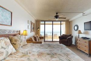 a bedroom with a bed and a couch and a television at Maui Kai 507 & 508 in Honokowai +30 photos