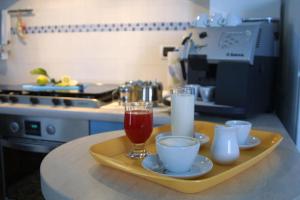a tray with drinks and cups on a kitchen counter at Villa Consorti in Martinsicuro