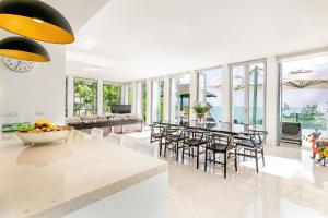 a kitchen and dining room with a table and chairs at Surin Heights Villa in Surin Beach