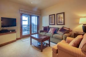 a living room with a couch and a table at The Cache in West Village in Copper Mountain