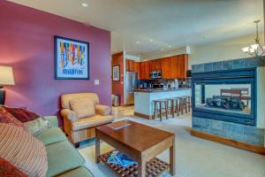 a living room with a couch and a fireplace at The Cache in West Village in Copper Mountain