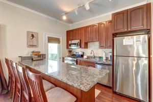 a kitchen with wooden cabinets and a stainless steel refrigerator at Okemo Trailside 6A in Ludlow