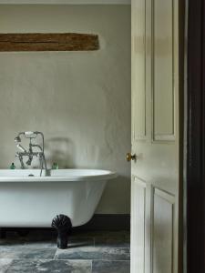 a bathroom with a white tub and a sink at The Cross at Croscombe in Wells +32 photos