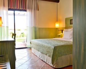 
A bed or beds in a room at Pestana Vila Sol Golf & Resort Hotel
