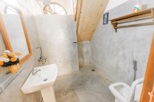 a bathroom with a sink and a toilet at Fort Sapphire in Galle