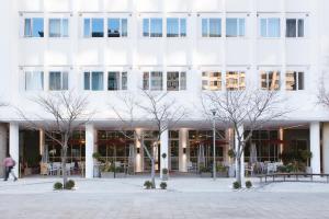 un edificio bianco con alberi di fronte di Signature Lux Hotel by ONOMO, Foreshore a Città del Capo