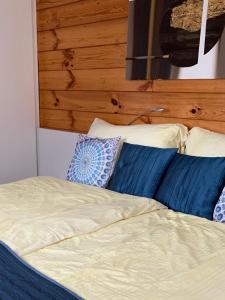a bed with pillows and pillows on top of it at Mazot Zermatt in Zermatt