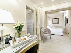 a hotel room with a bed and a table at Hotel Barocco in Rome