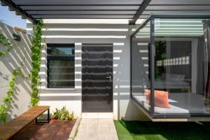 a house with a glass door on a patio at Color Coral Boutique Hotel in Magong +65 photos