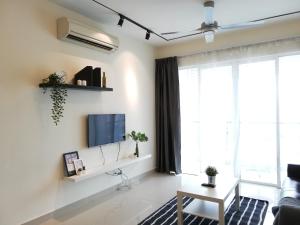 a living room with a tv on a wall at Ara Damansara Oasis Residence, Specious Home 4-8pax, 8min Subang Airport, 10min Sunway in Petaling Jaya