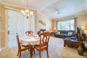 a dining room and living room with a table and chairs at Pristine Top Floor Condo With Access To Clubhouse & Pools in Phoenix