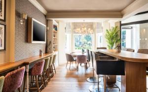 a dining room with a table and chairs at Point A Kensington Olympia in London
