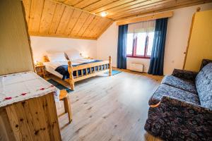 a bedroom with two beds in a room with wooden ceilings at Country House Sara in Rečica ob Savinji