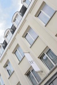 a building with windows and a sign on it at House 22 in Kortrijk