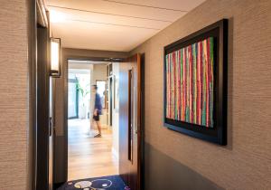 a hallway with a painting hanging on a wall at Point A Kensington Olympia in London