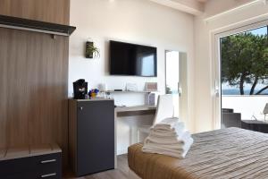 a bedroom with a bed with a desk and a television at Casablanca Hotel in Civitanova Marche