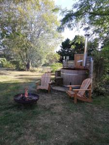 a backyard with two chairs and a fire pit at Chambres d'hôtes Sandrine Louis in Phalsbourg