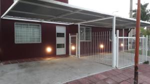 a house with an open garage with lights on it at Aqua Duplex in Villa Carlos Paz