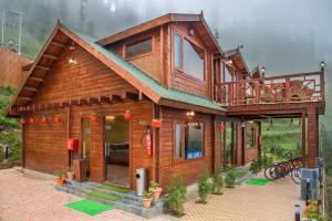 a model of a wooden house with a balcony at Woodays Resort in Shimla