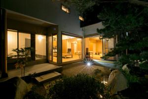 a house with a view of the backyard at night at Waso Mukuge in Sakaiminato