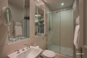 a bathroom with a shower and a sink and a toilet at Woodlands Park Hotel in Cobham