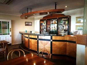 Un bar en un restaurante con mesas y sillas. en Zevenwacht Cottages, en Kuilsrivier
