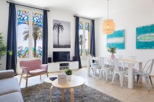 a living room with a table and chairs at Sitges Group Ocean in Sitges