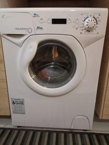 a white washing machine sitting on a shelf at la casetta nel cortile in Catania