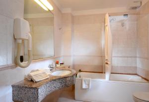 a bathroom with a sink and a tub and a toilet at Cà Rialto in Venice