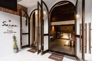 a lobby with an open door with a potted plant at Saran Boutique Hotel Thapae in Chiang Mai