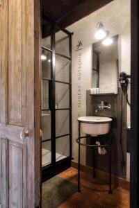 a bathroom with a sink and a mirror at Noliktava No 5 in Kuldīga