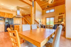 a kitchen and dining room with a wooden table and chairs at Coyote Run 1 in Moab