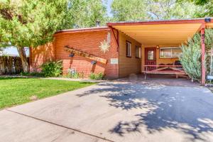 a brick house with a porch and a patio at Creekside Juanita's Place in Moab