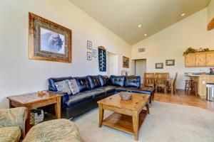 a living room with a blue couch and a table at Rim Village N1 in Moab