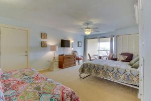 a bedroom with two beds and a living room at Marina Retreat in South Padre Island