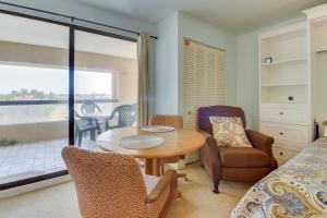 a living room with a table and chairs at Marina Retreat in South Padre Island