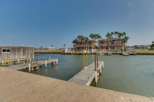 a marina with houses and a dock in the water at Marina Retreat in South Padre Island