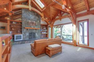 a living room with a couch and a fireplace at Bottle Bay Lakefront Lodge in Sandpoint