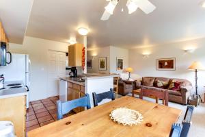 a kitchen and living room with a wooden table and a dining room at Solano Vallejo 3329 in Moab