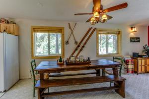 a dining room with a wooden table and a ceiling fan at Strawberry Log Cabin Retreat in McCall