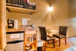 a kitchen with two chairs and a counter with a table at Creekside Cowa-Bungalow! in Moab