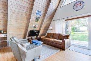 a living room with a couch and a tv at A-Frame Hideaway in Neskowin