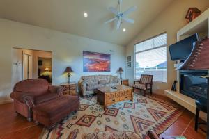 a living room with a couch and a tv at Rim Village O3 in Moab