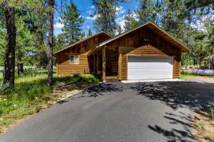 a log cabin with a garage on a road at Strawberry Log Cabin Retreat in McCall