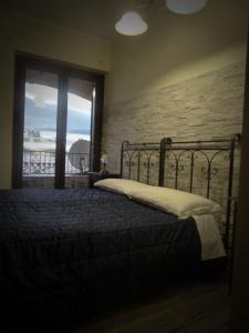 a bedroom with a bed and a window with a view at B&B Massari in Preturo