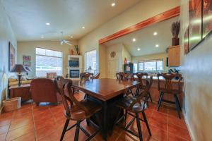 a kitchen and dining room with a wooden table and chairs at Rim Village O3 in Moab