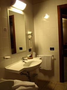 a bathroom with a sink and a mirror at Hotel Fondo Catena in Ferrara